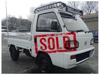 a white truck with a sold sign on it