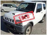 a white truck with a sold sign on it