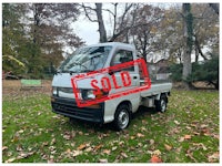 a white truck with a sold sign on it