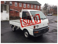 a white truck with a sold sign on it