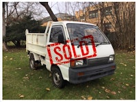 a white truck with a sold sign on it