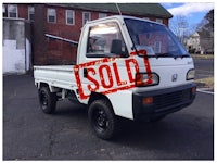 a white truck with a sold sign on it