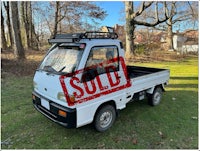 a white truck with a sold sign on it