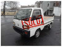 a white truck with a sold sign on it is parked in a parking lot