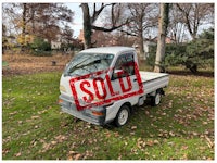 a white truck with a sold sign on it