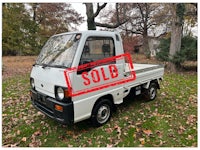 a white truck with a sold sign on it